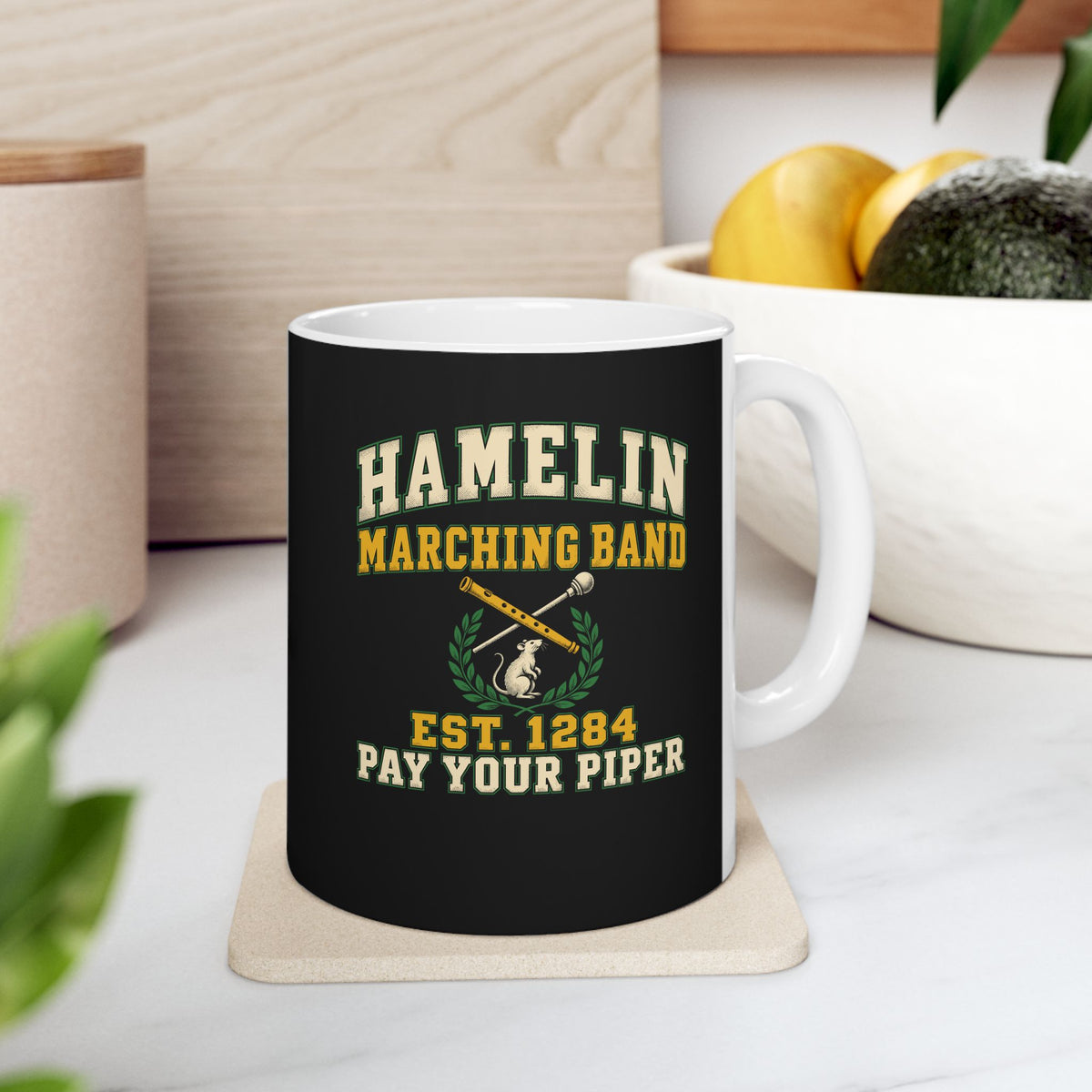 Hamelin Marching Band Pay Your Piper ceramic mug, 11oz, on a kitchen counter