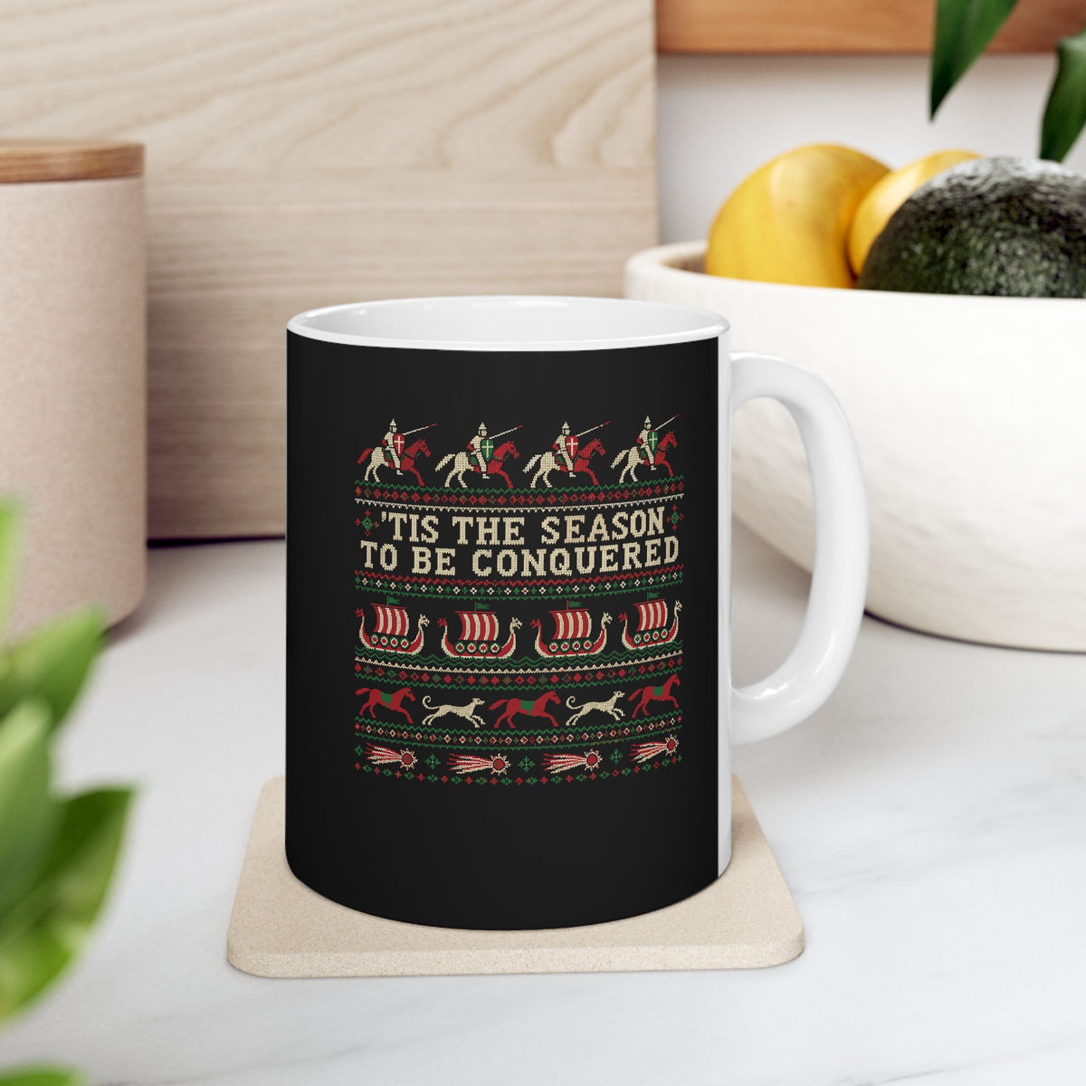 'Tis the Season to Be Conquered ceramic mug, 11oz, on a kitchen counter