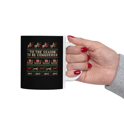'Tis the Season to Be Conquered ceramic mug, 15oz, held in hand